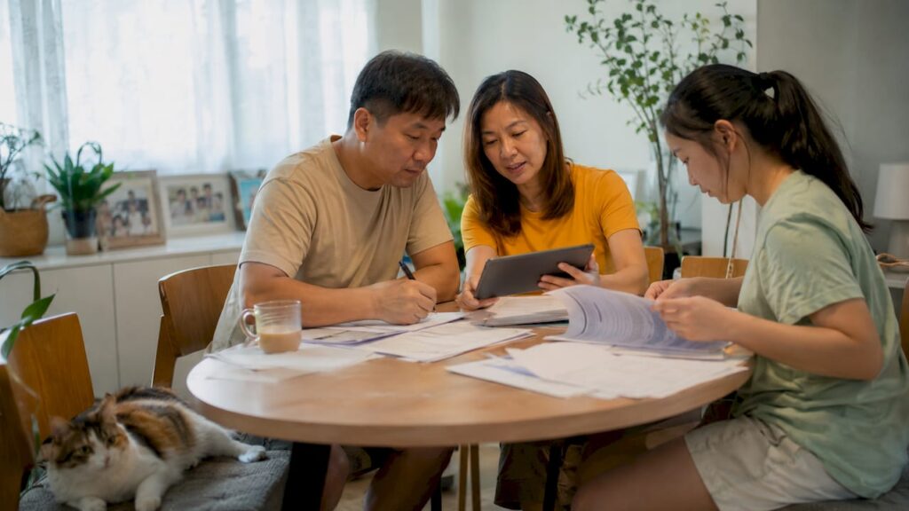 Family preparing HDB submission documents at home
