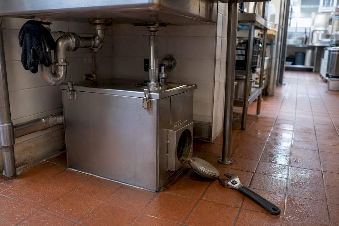 Grease trap installation in commercial kitchen