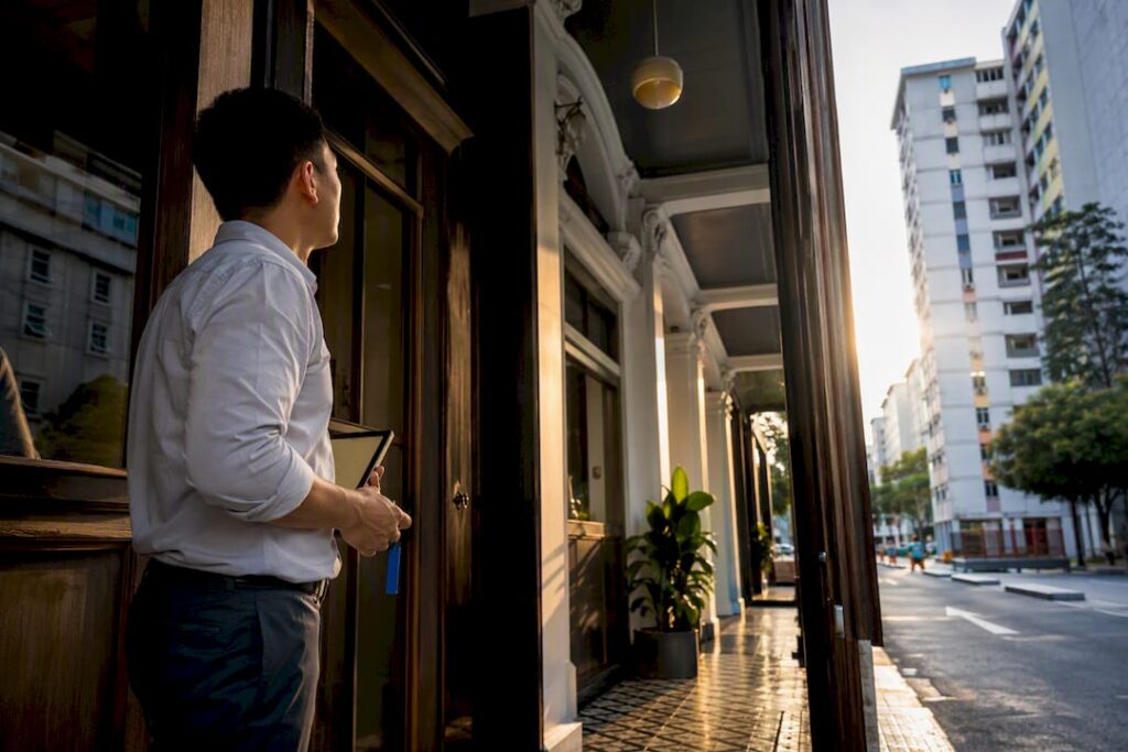 Consultant assessing Singapore shophouse frontage