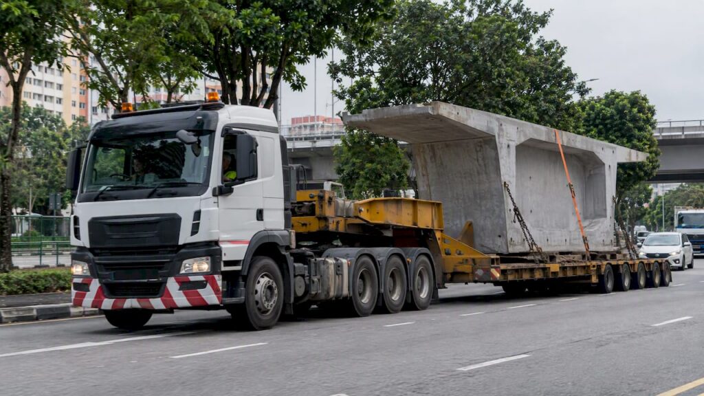 Low-loader carrying a wide construction load