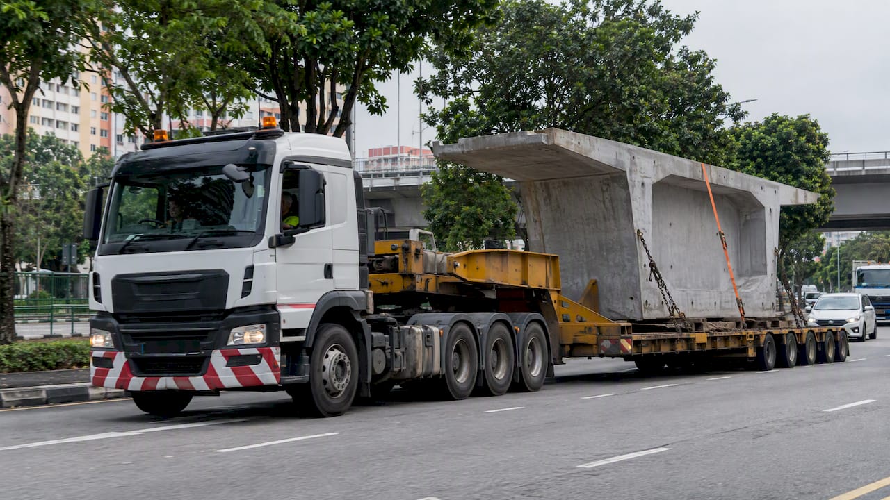 Low-loader carrying a wide construction load