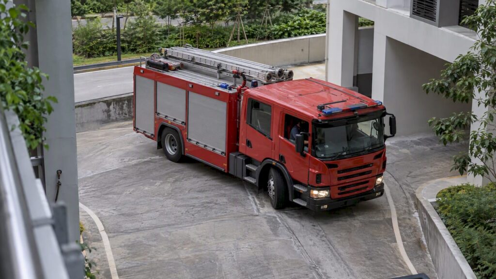 Fire engine turning beside a Singapore building