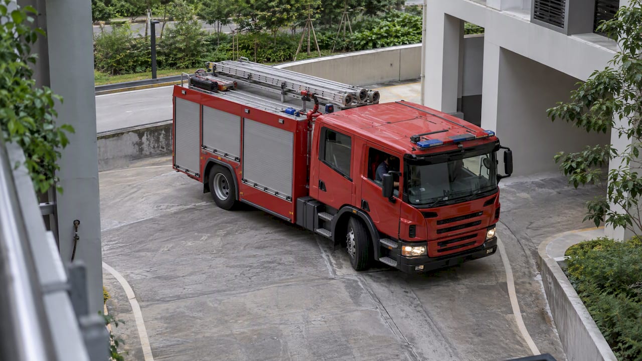 Fire engine turning beside a Singapore building